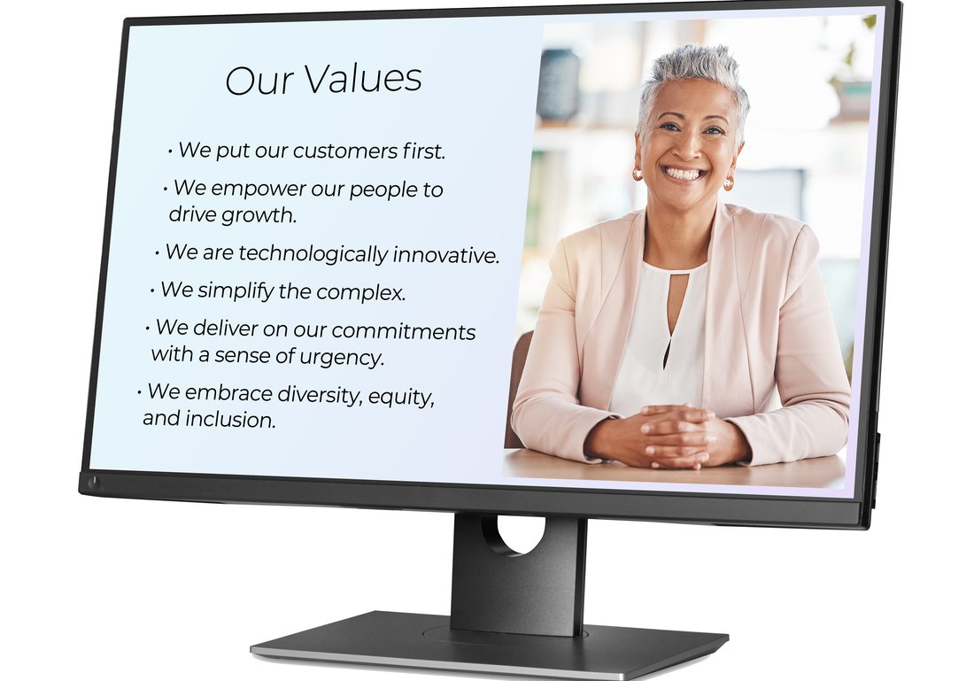 A desktop monitor showing the six core values listed beside a portrait photograph